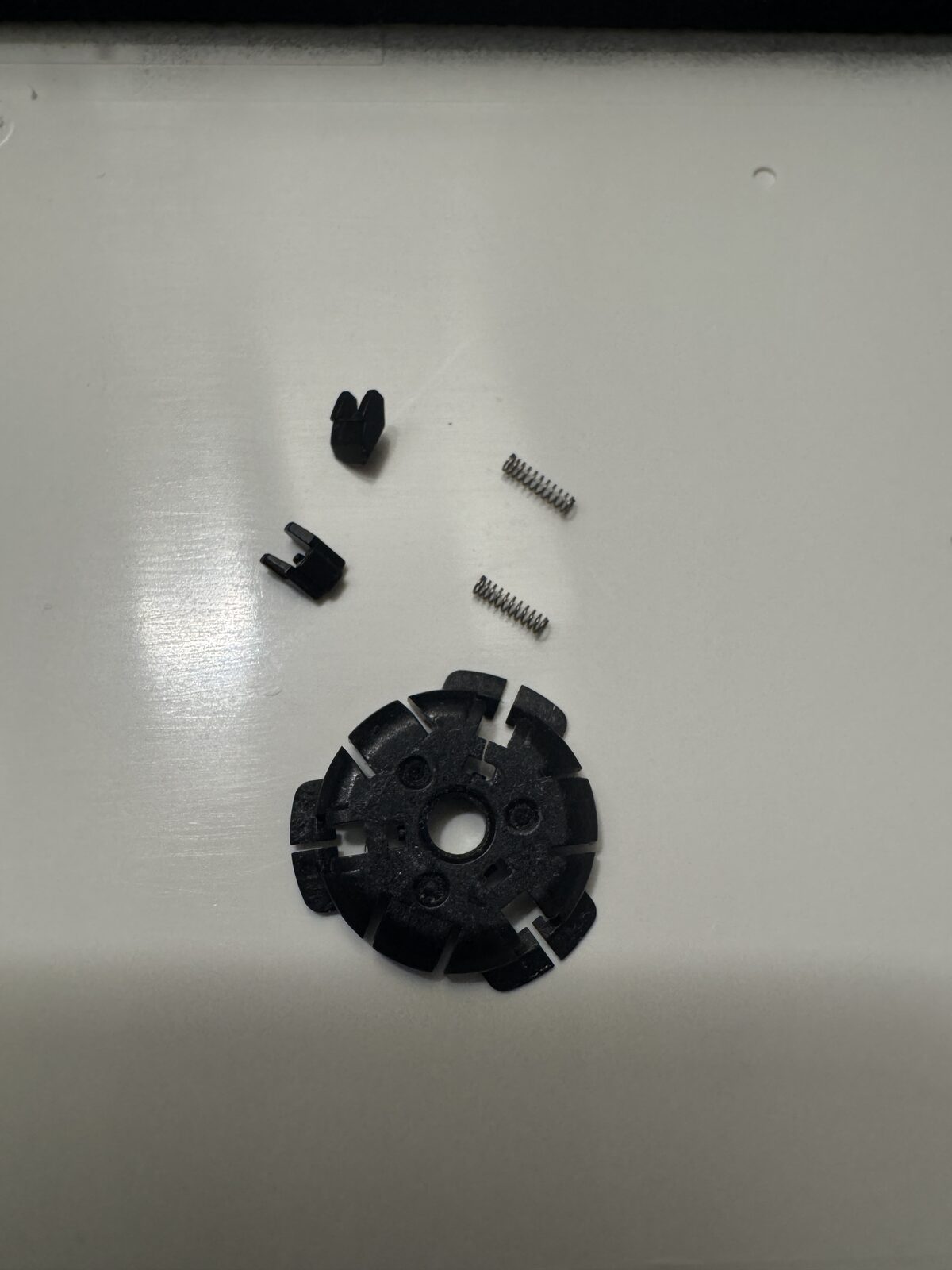 Fig 3: Spindle / Hub (bottom face), 2 recovered springs and clips.