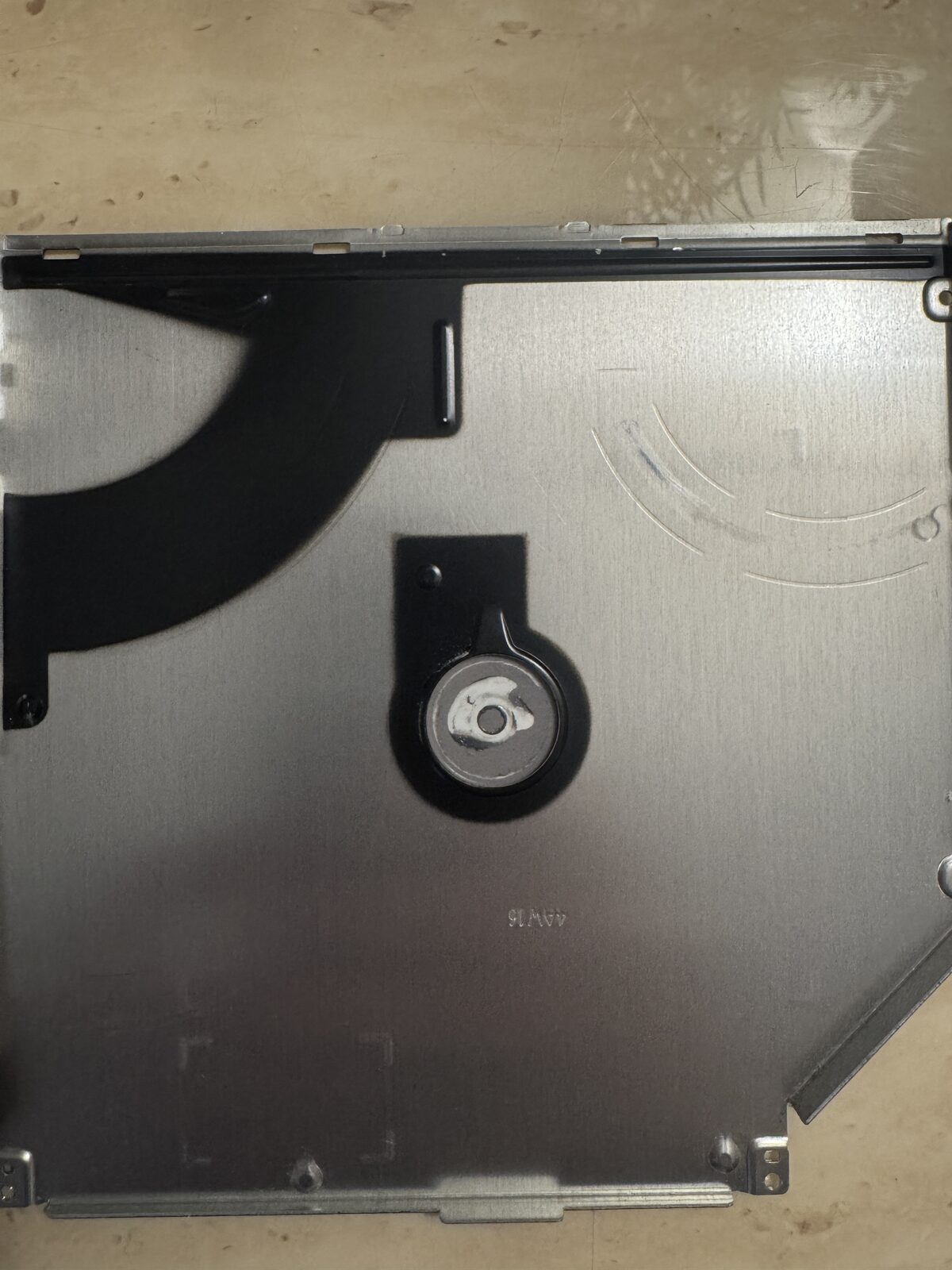 Fig 2: Inner face of top cover showing the hub cradle and what appears to be adhesive compound